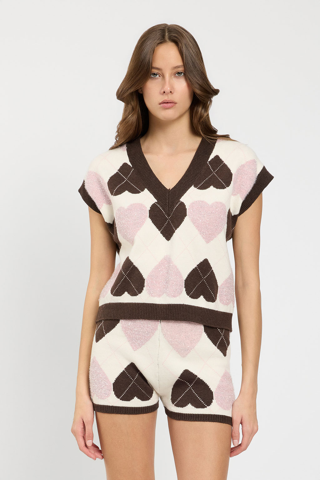 Gilet da donna in maglia marchio TWINSET con lavorazione jacquard piquet motivo cuori e check con scollo a V su Origami Store